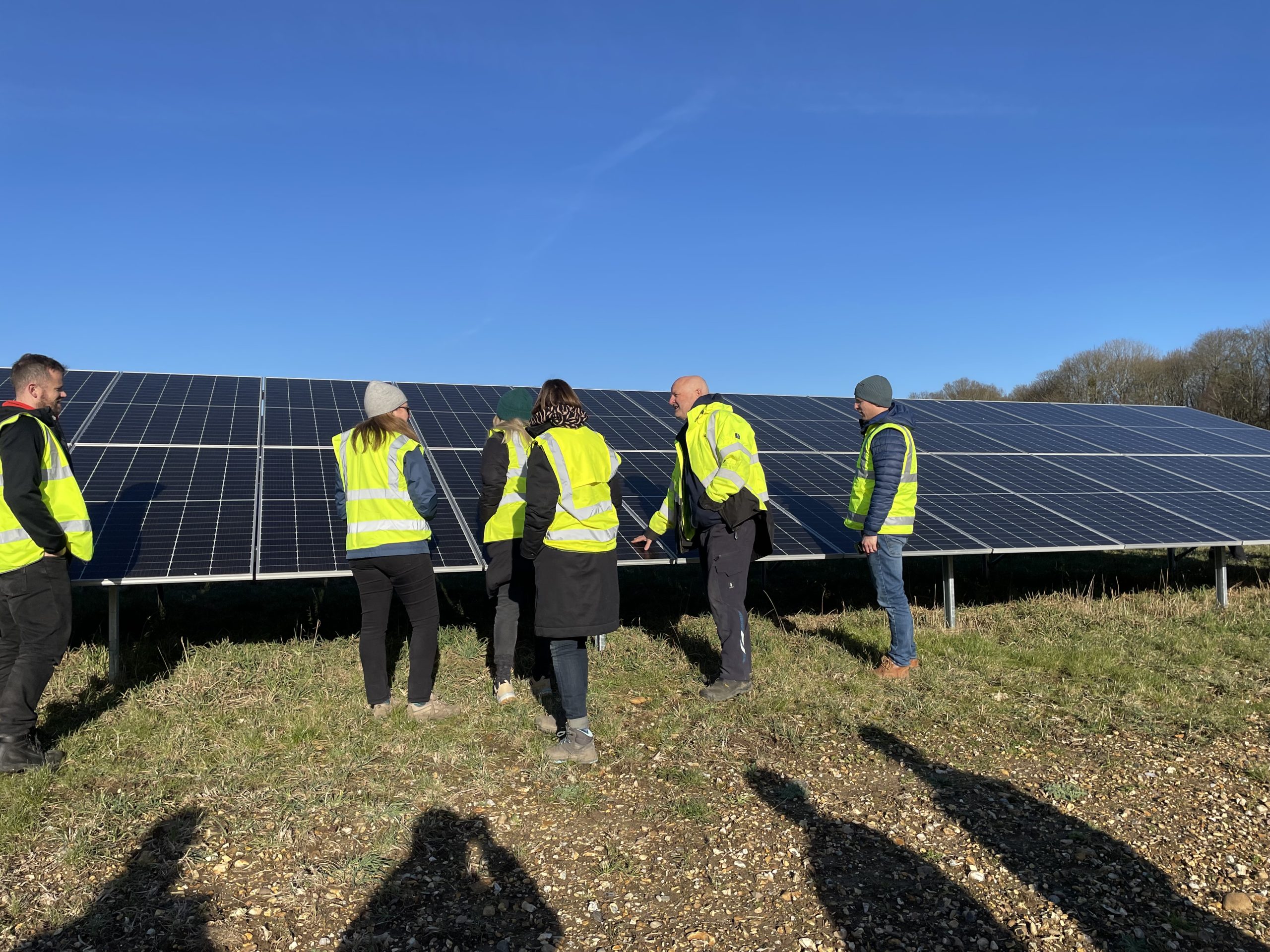 The One Earth project team enjoys a site visit to one of our working solar farms
